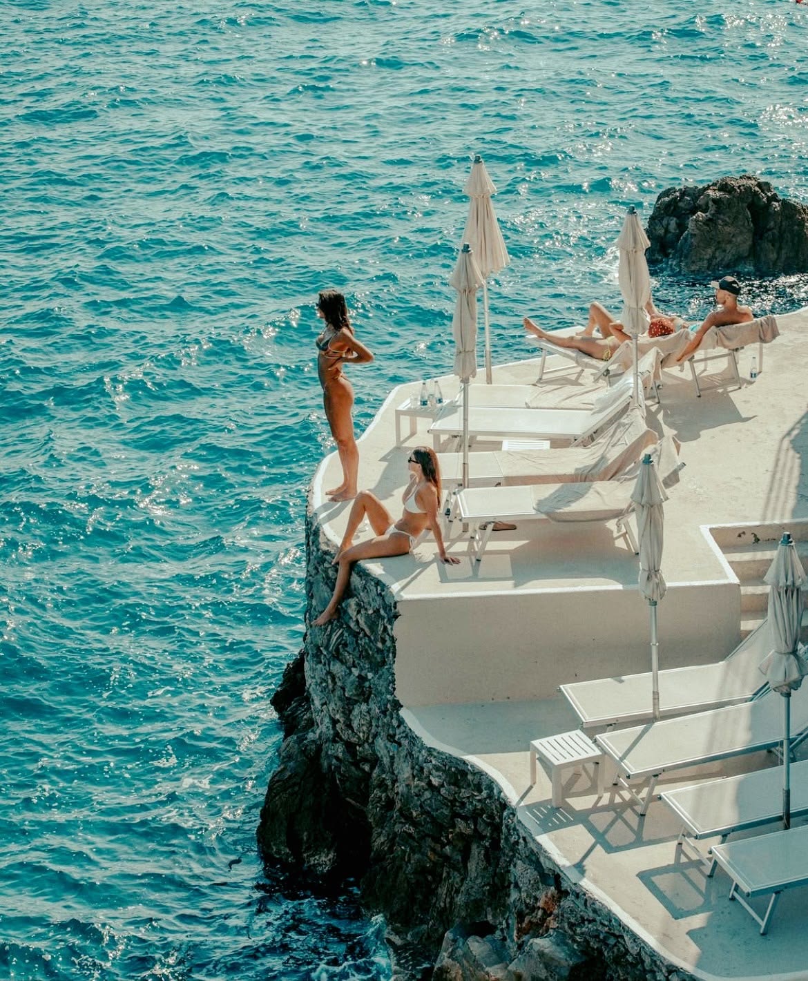 Clifftop pool overlooking the sea at golden hour